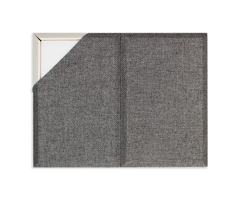 A Fabricmate Sample Panel meant to represent a fabric wall installation. The corner of the fabric is pulled back to reveal the acoustic friendly and tackable frame and backing as it would appear on a wall installation