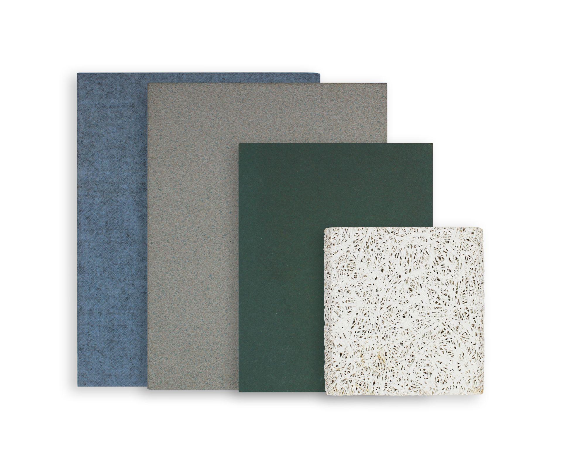 A collection of competitor products stacked on top of each other. Includes a Vinyl wrapped wall panel, a cork wall panel, a foam wall panel, and a tectum wall panel