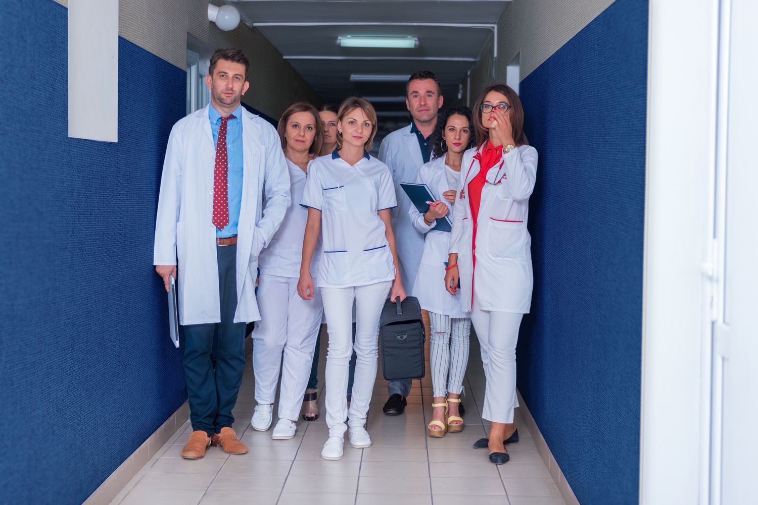 hospital hallway with parallel fabric panel with doctors and nurses posing