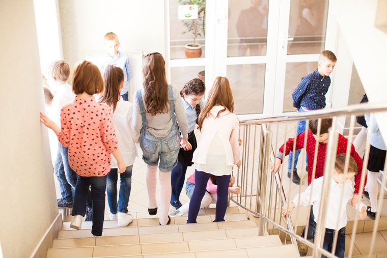 kids in hallway on stairs - high traffic areas get touched, bumped, and scuffed often