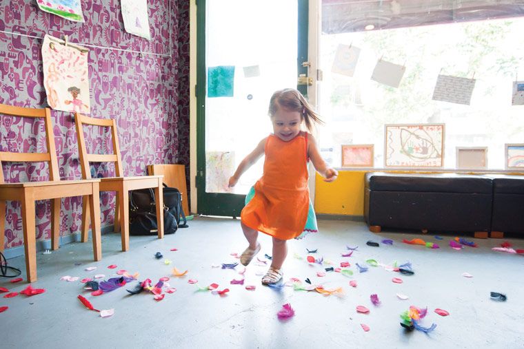 safe wall coverings for nurseries - child running with custom printed wall covering in background