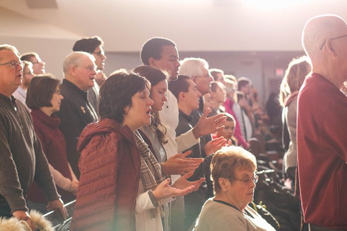 People at Church listening to and singing music 